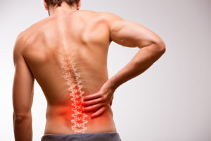 A man holds his lower back, overlaid on his back is an image of his spine with red marks for pain points.
